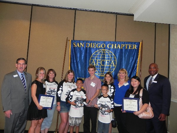 SAN DIEGO—In June, Kelly (l) and Hobson, (r) greet scholarship winners and kids from the science fair.